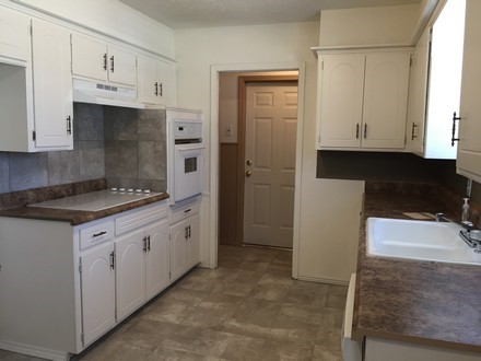 A kitchen with a sink and a microwave