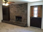A brick fireplace in a living room