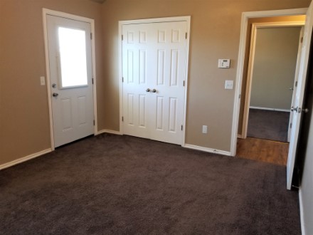 A double door leading to the closet in the living room