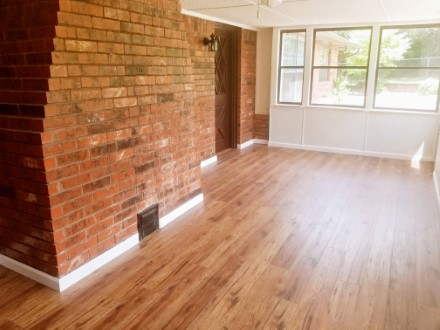 A large brick fireplace with a hard wood floor