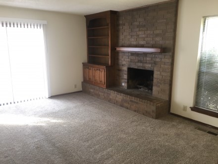Living room with fireplace and cabinets