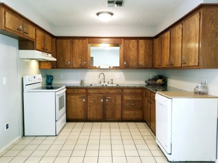 A kitchen with a sink and a refrigerator
