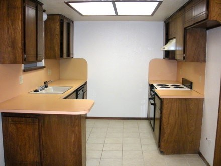 A kitchen with a sink and a refrigerator