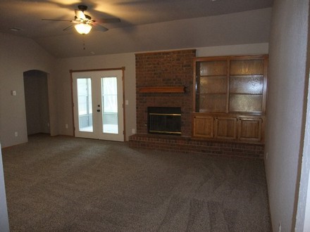 Living room with fireplace and carpeting
