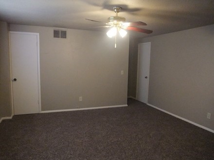 Carpet flooring and overhead light with fan