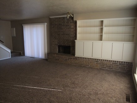 A living room with a brick fireplace