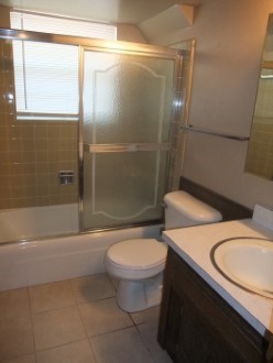 A large tub next to a glass shower door