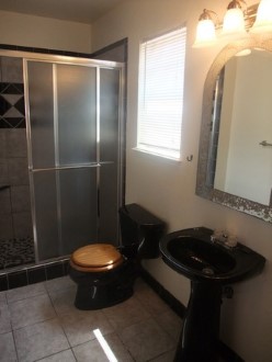 The bathroom with a glass shower door