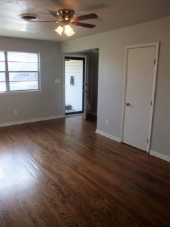 A large living room with a hard wood floor