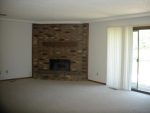 A living room with a brick fireplace