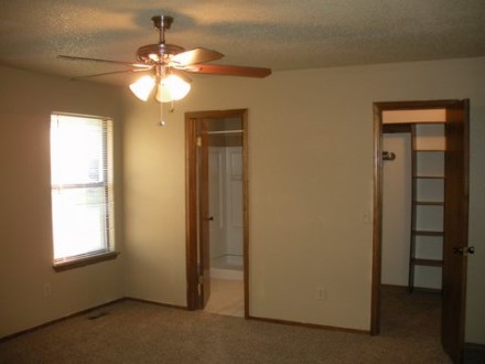 A large room with a ceiling fan
