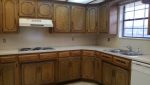 A kitchen with wooden cabinets