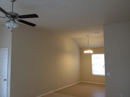 A view of a room with a ceiling fan